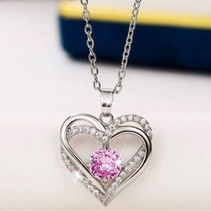 Silver heart necklace with a pink jewel